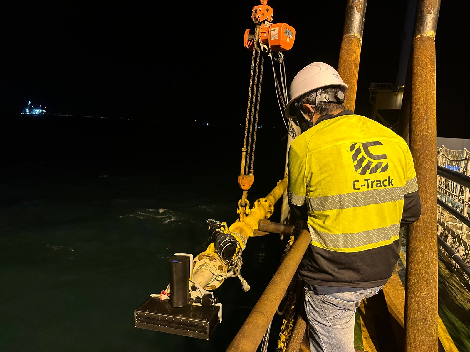 C-TRACK crew deploying a pole-mounted multibeam echosounder at night